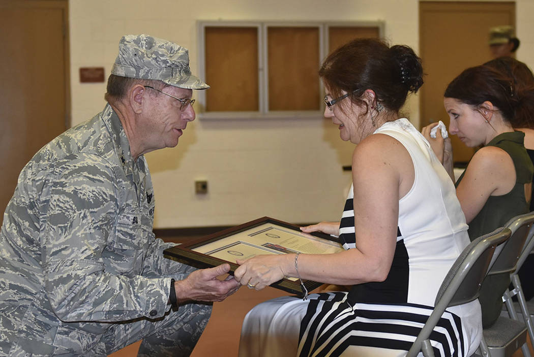 Nevada Adjutant General Brig. Gen. Bill Burks, left, presents Margie Gallagher her husband's po ...