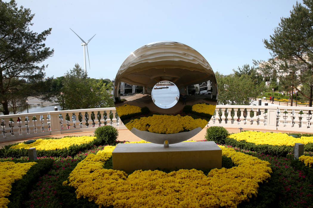 The Mystic River is seen through David Harber's Torus sculpture in the porte-cochere at Encore ...