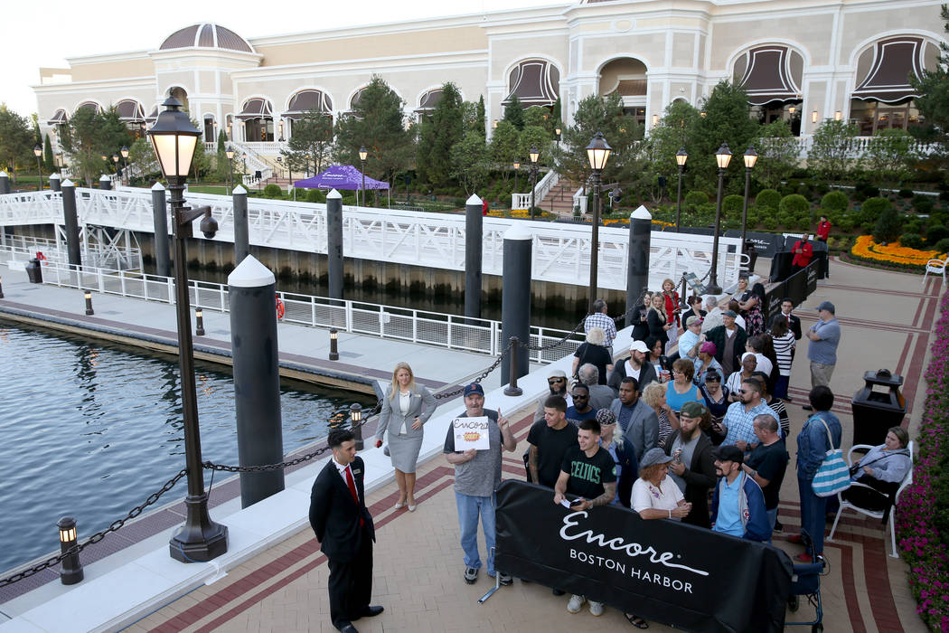 Glenn Reynolds, 65, of Quincy, Mass., third from left, is first in line for the opening of the ...