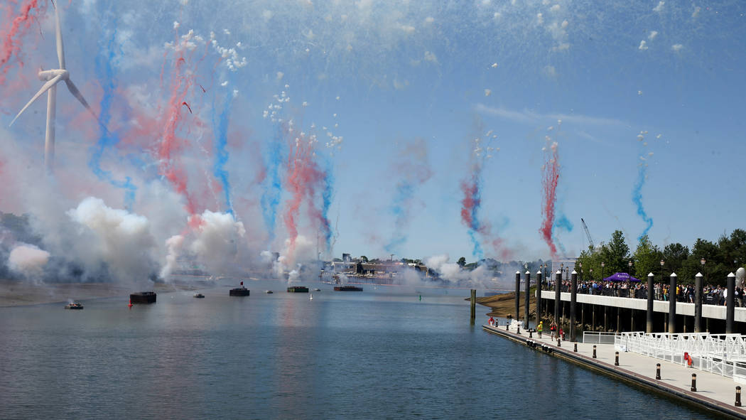 Workers and guests watch fireworks during the opening of the $2.6 billion Encore Boston Harbor ...