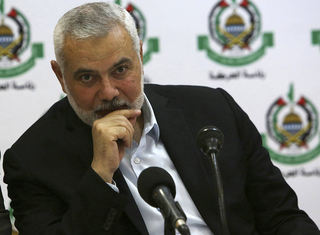 Hamas' chief Ismail Haniyeh attends a meeting with foreign reporters at al-Mat'haf hotel in Gaz ...