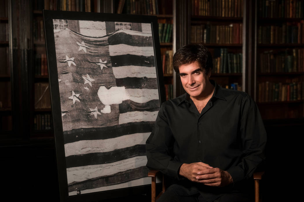 Magic legend David Copperfield is shown with an image of the original Star-Spangled Banner at t ...