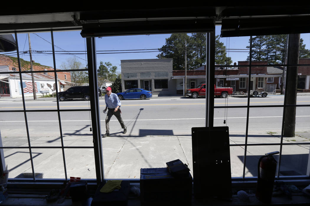 In this photo taken Wednesday, April 17, 2019 town manager Glenn Spivey crosses Jones Street in ...