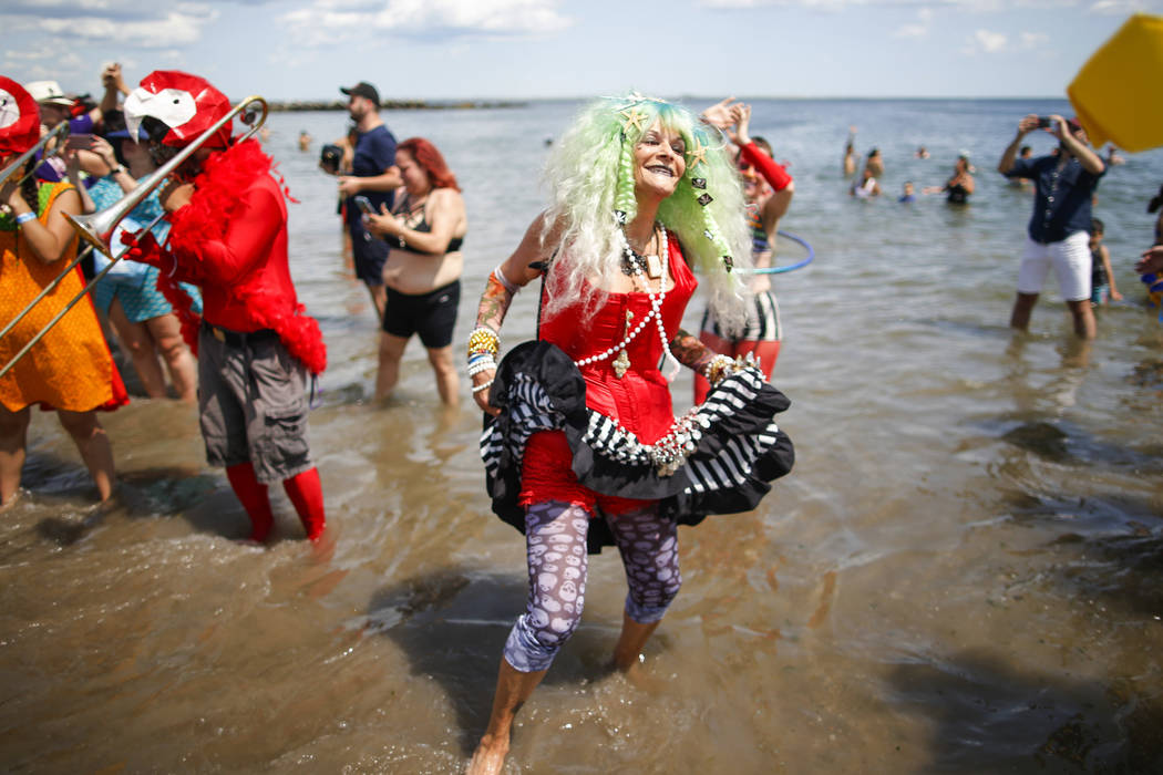 Parade attendees in costume make their way along Surf Avenue during the 37th annual Mermaid Par ...