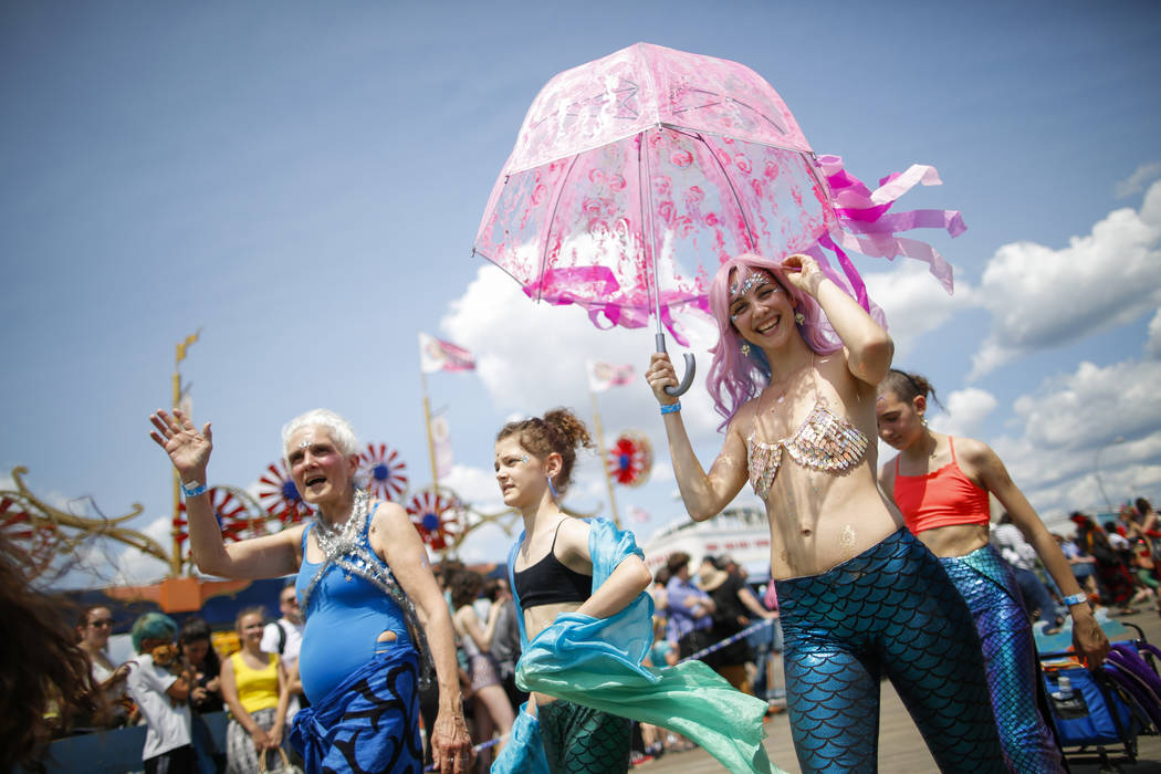 Parade attendees in costume make their way along Surf Avenue during the 37th annual Mermaid Par ...