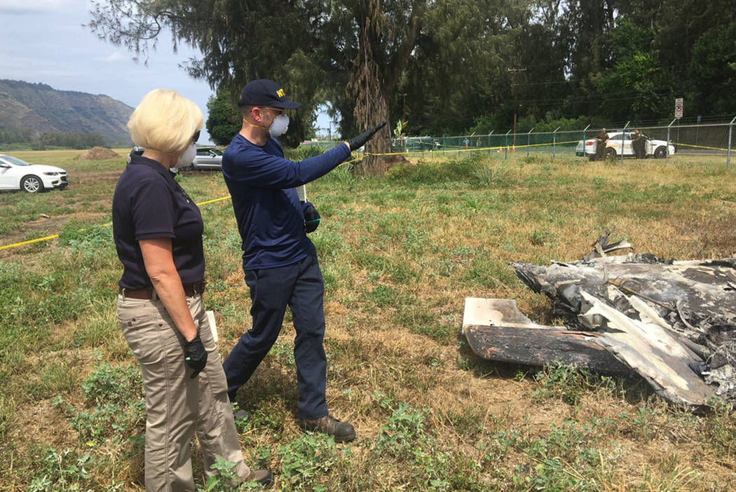 National Transportation Safety Board investigator Eliott Simpson briefs NTSB member Jennifer Ho ...