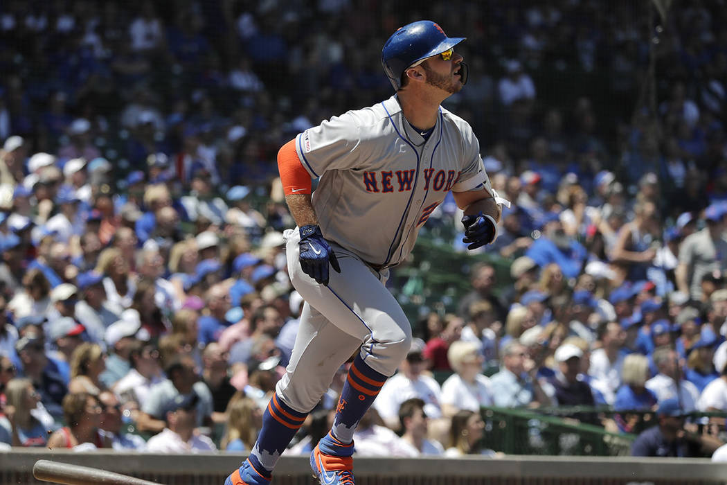 New York Mets' Pete Alonso watches after hitting a solo home run against the Chicago Cubs durin ...