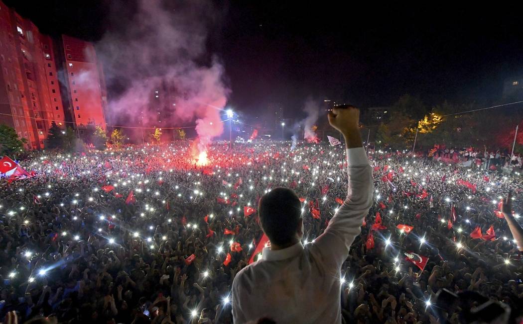 Ekrem Imamoglu, the candidate of the secular opposition Republican People's Party, CHP, waves t ...