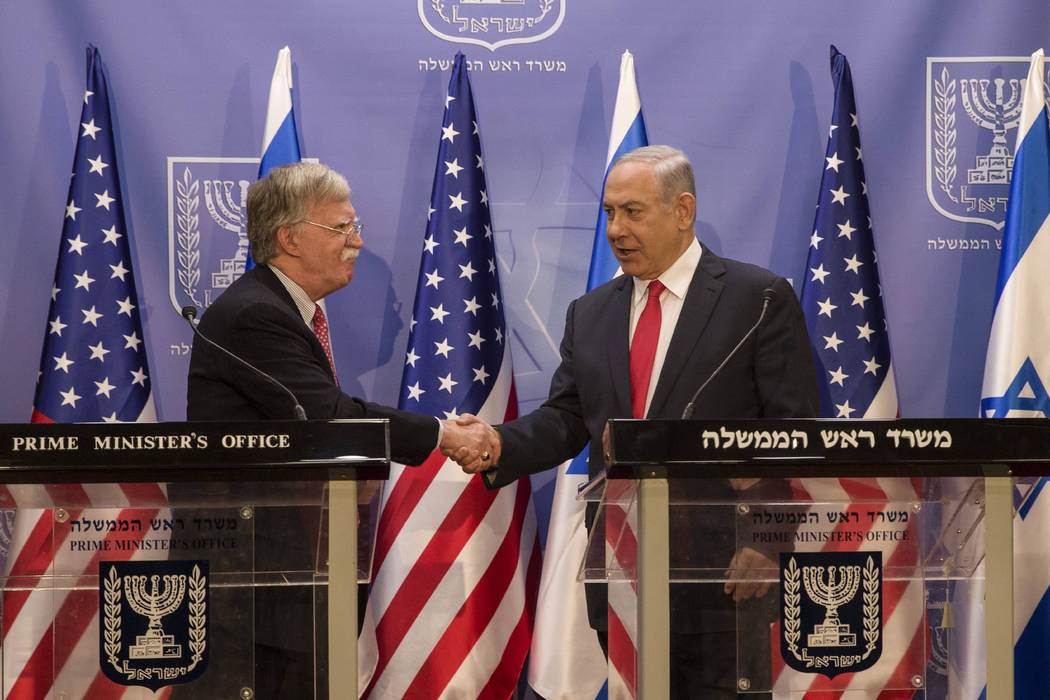 Israeli Prime Minister Benjamin Netanyahu, right, shakes hands with U.S. National Security Advi ...