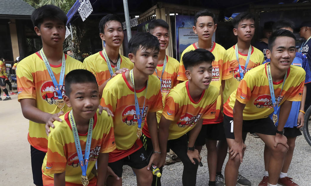 Members of the Wild Boars soccer team who were rescued from a flooded cave, pose for the media ...