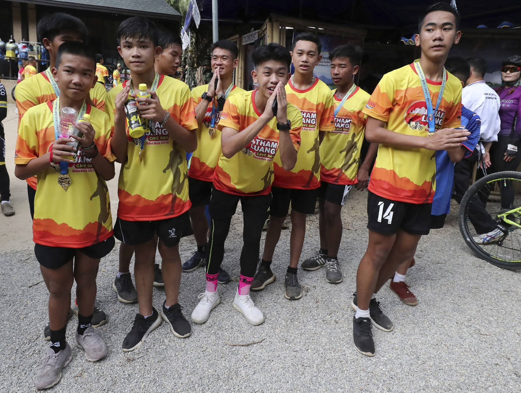 Members of the Wild Boars soccer team who were rescued from a flooded cave, pose for the media ...