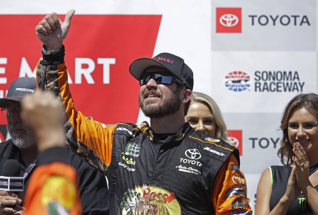 Martin Truex Jr. celebrates after winning a NASCAR Sprint Cup Series auto race Sunday, June 23, ...