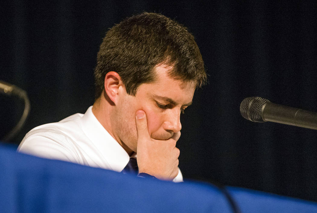 Democratic presidential candidate and South Bend Mayor Pete Buttigieg looks down during a town ...