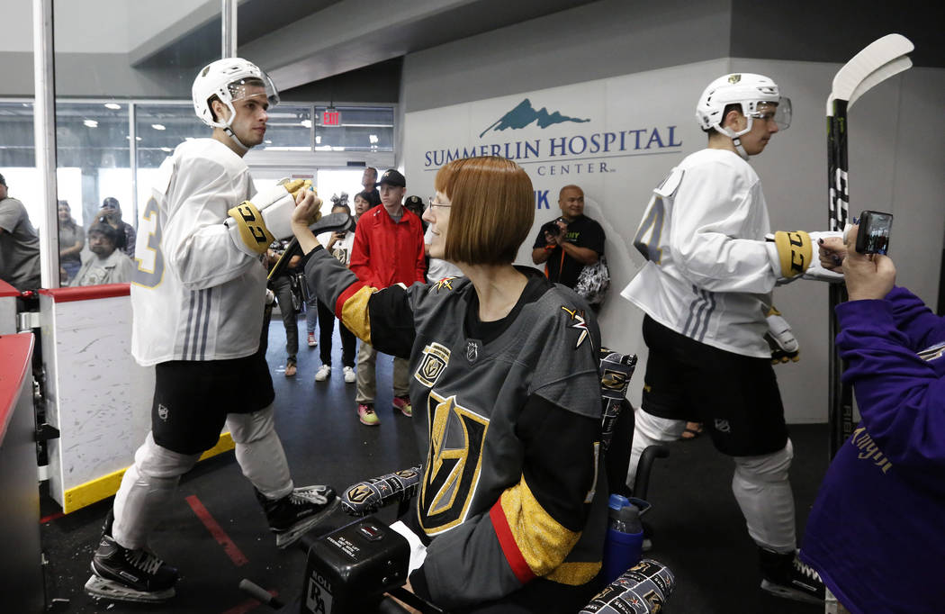 Vegas Golden Knights prospect Gage Quinney makes a fist bump with Shannon Walker of Las Vegas a ...