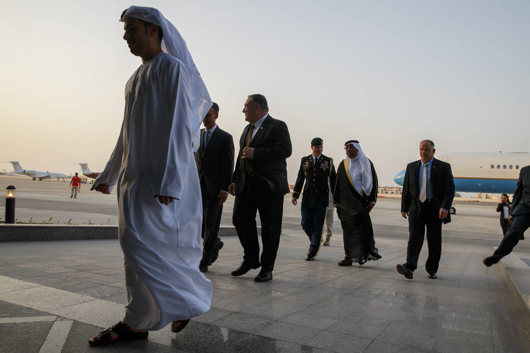 U.S. Secretary of State Mike Pompeo, center, walks with U.S. Charge d'Affaires Steve Bondy, sec ...