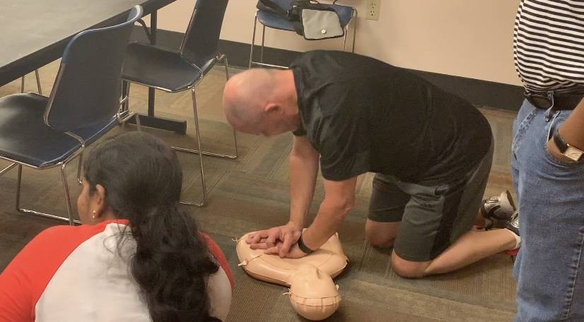 Tim Williams practices chest compressions during a Health and Hands Only CPR class at the Summe ...