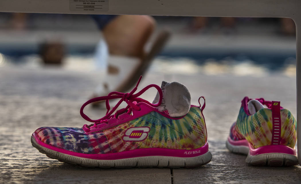 Rainbow sneakers are left under a lounge chair in the pool area during Pride Night at the Las V ...