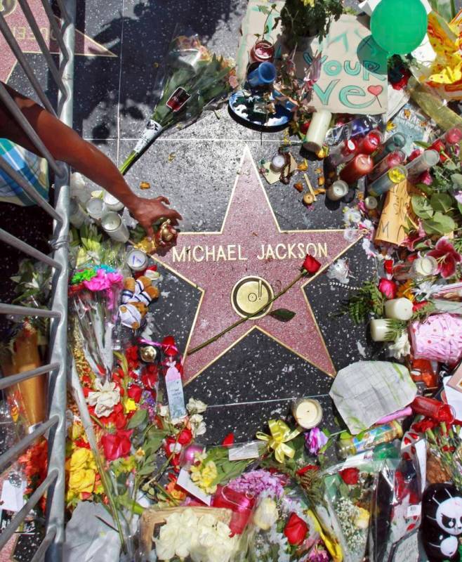 This June 26, 2009 file photo shows a sidewalk shrine of mementos, flowers and candles adorning ...