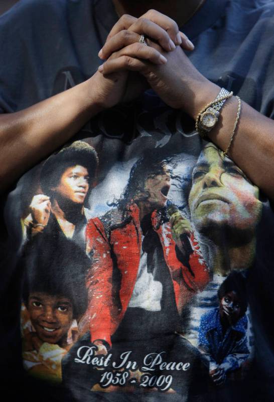 This June 30, 2009 file photo shows a fan wearing a Michael Jackson T-shirt at a makeshift memo ...