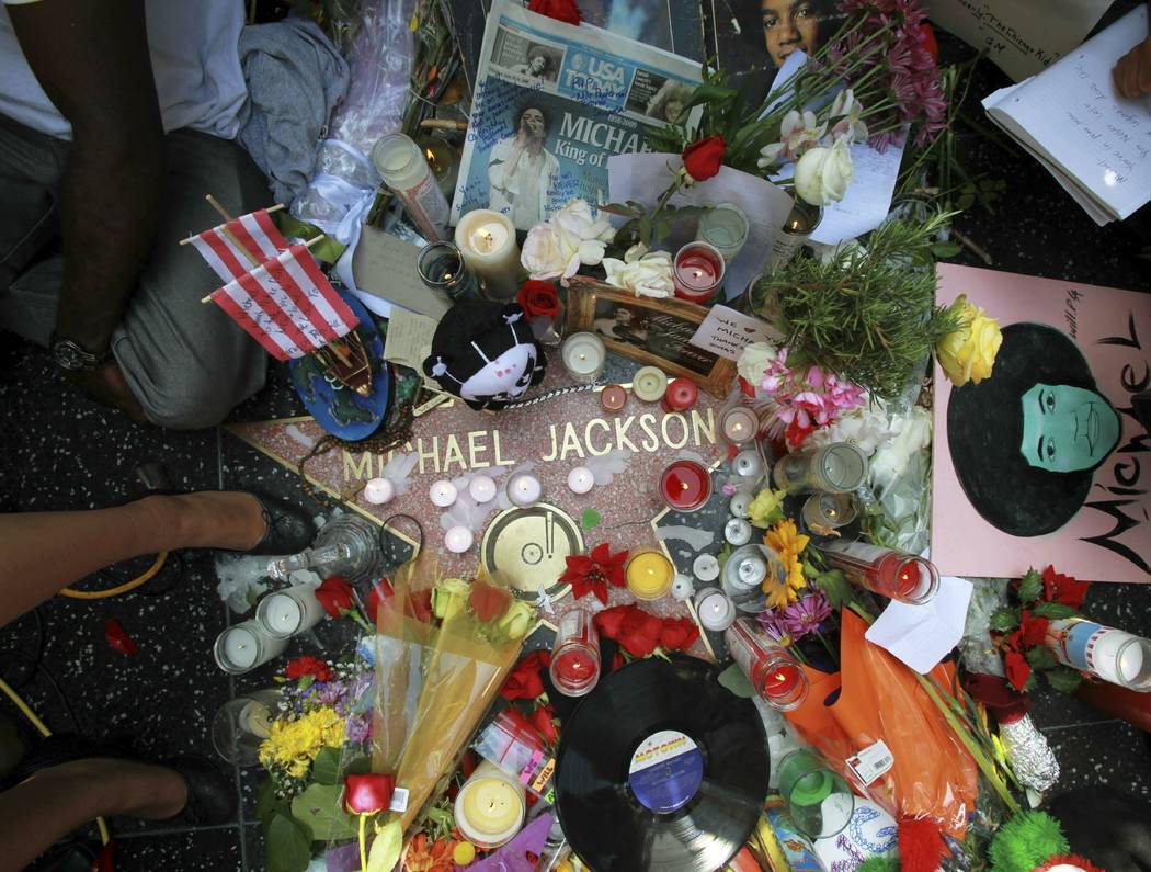 This June 26, 2009 file photo shows a sidewalk shrine of mementos, flowers and candles adorning ...