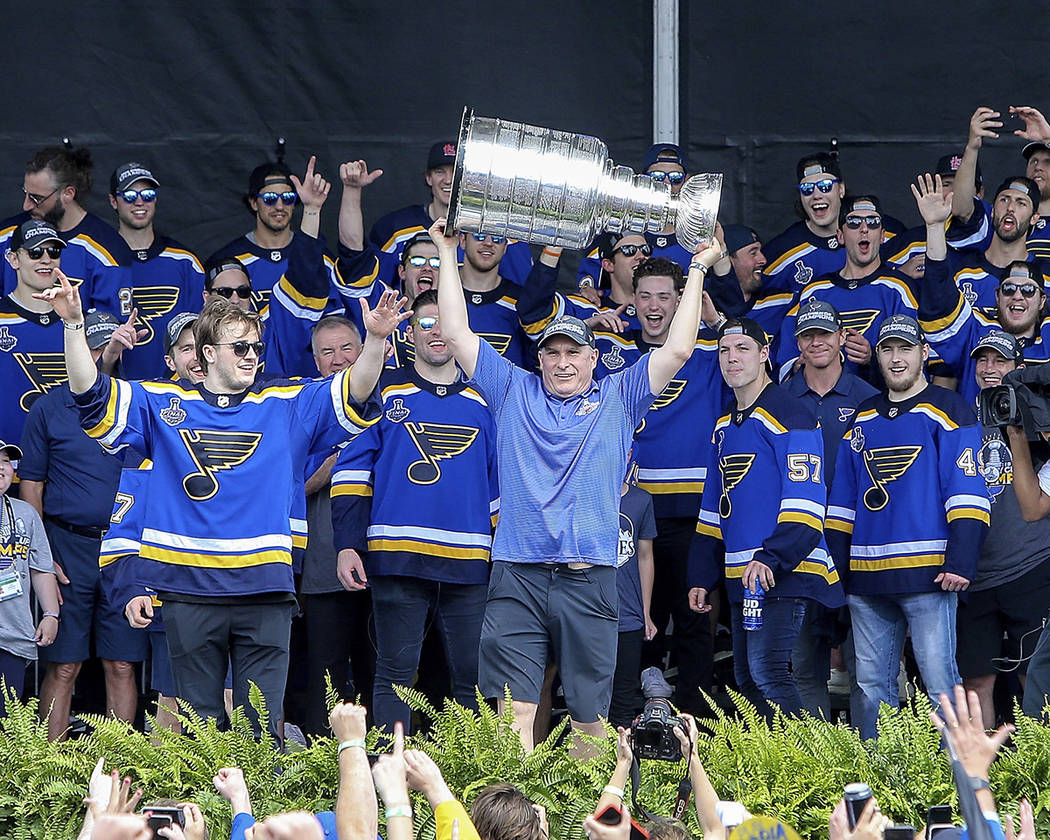 St. Louis Blues head coach Craig Berube holds the Stanley Cup overhead during the NHL hockey St ...