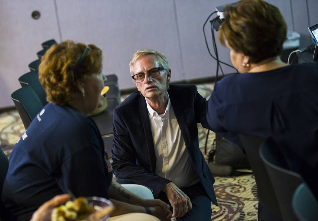 Steven Tomlinson, president of the Stonewall Democratic Club of Southern Nevada, talks with Don ...