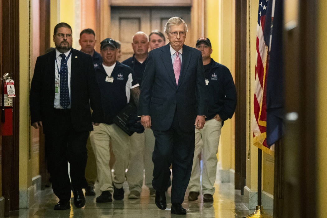 Senate Majority Leader Mitch McConnell walks with Sept. 11 first responders John Feal, second f ...