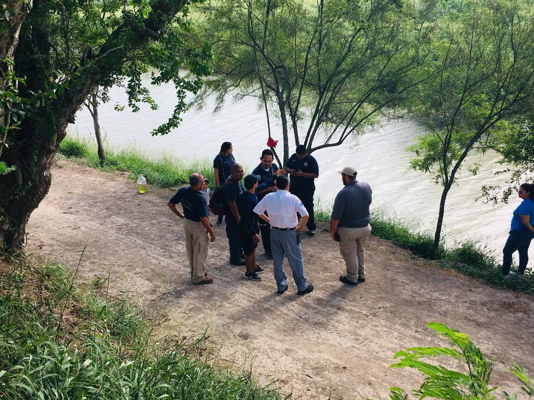 Mexican authorities stand along the Rio Grande bank where the bodies of Salvadoran migrant Osca ...