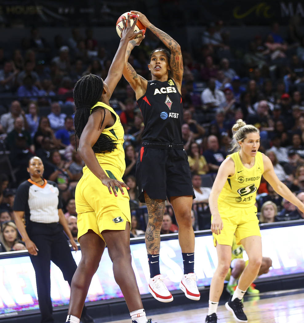 Las Vegas Aces forward Tamera Young shoots over Seattle Storm forward Crystal Langhorne during ...