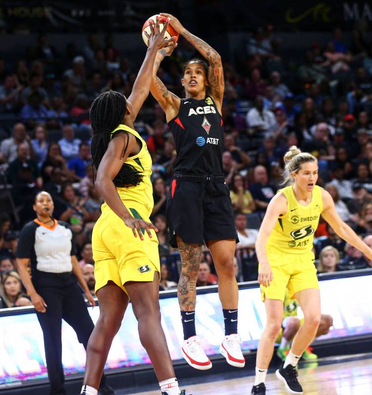 Las Vegas Aces forward Tamera Young shoots over Seattle Storm forward Crystal Langhorne during ...