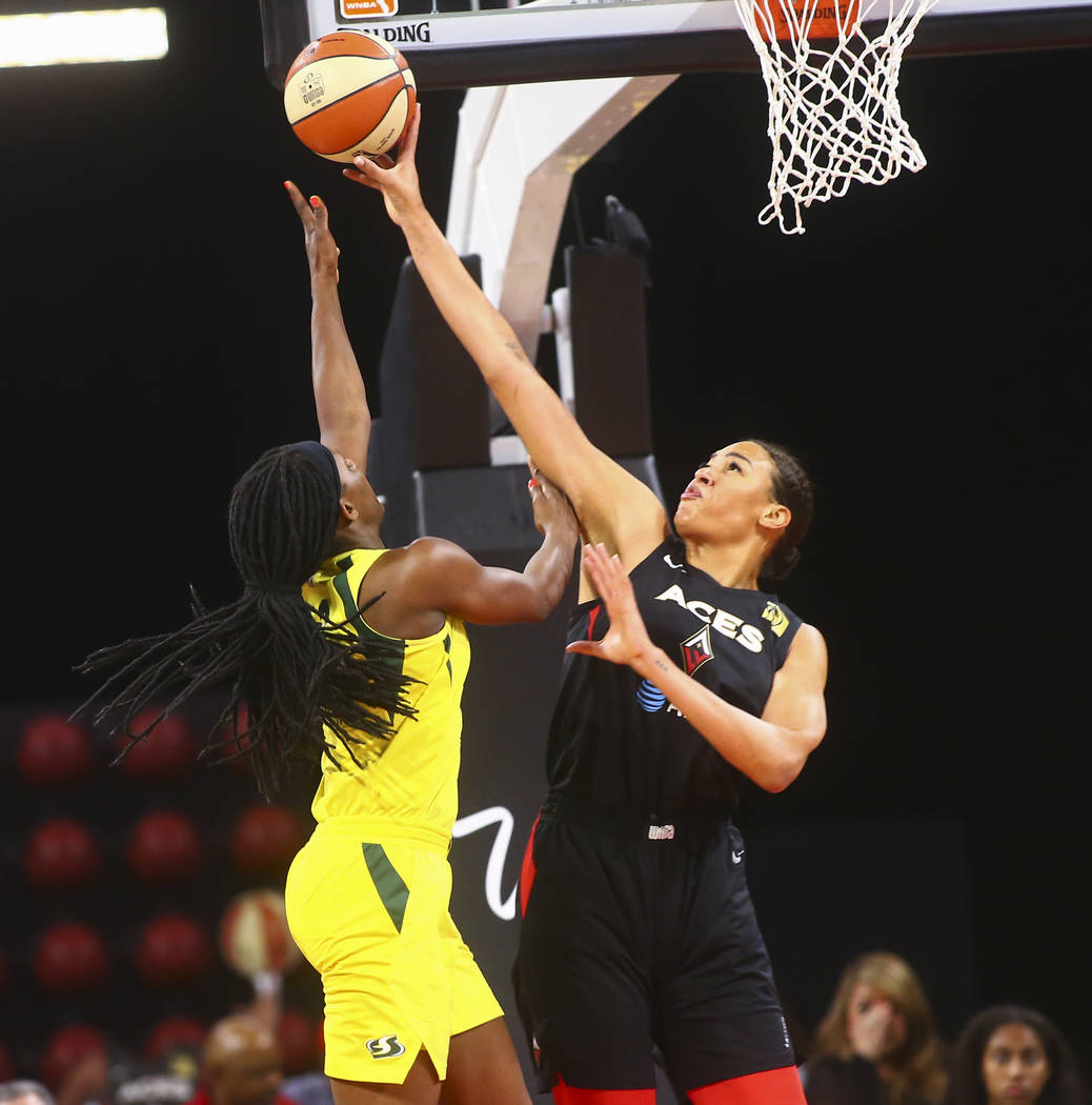 Las Vegas Aces center Liz Cambage, right, blocks a shot from Seattle Storm forward Crystal Lang ...