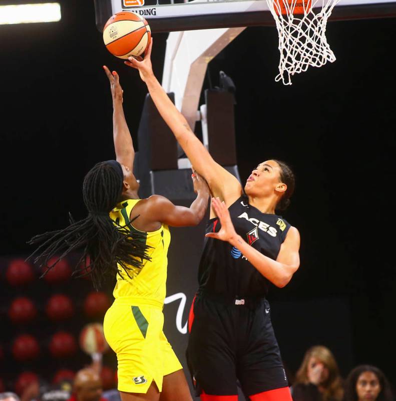 Las Vegas Aces center Liz Cambage, right, blocks a shot from Seattle Storm forward Crystal Lang ...