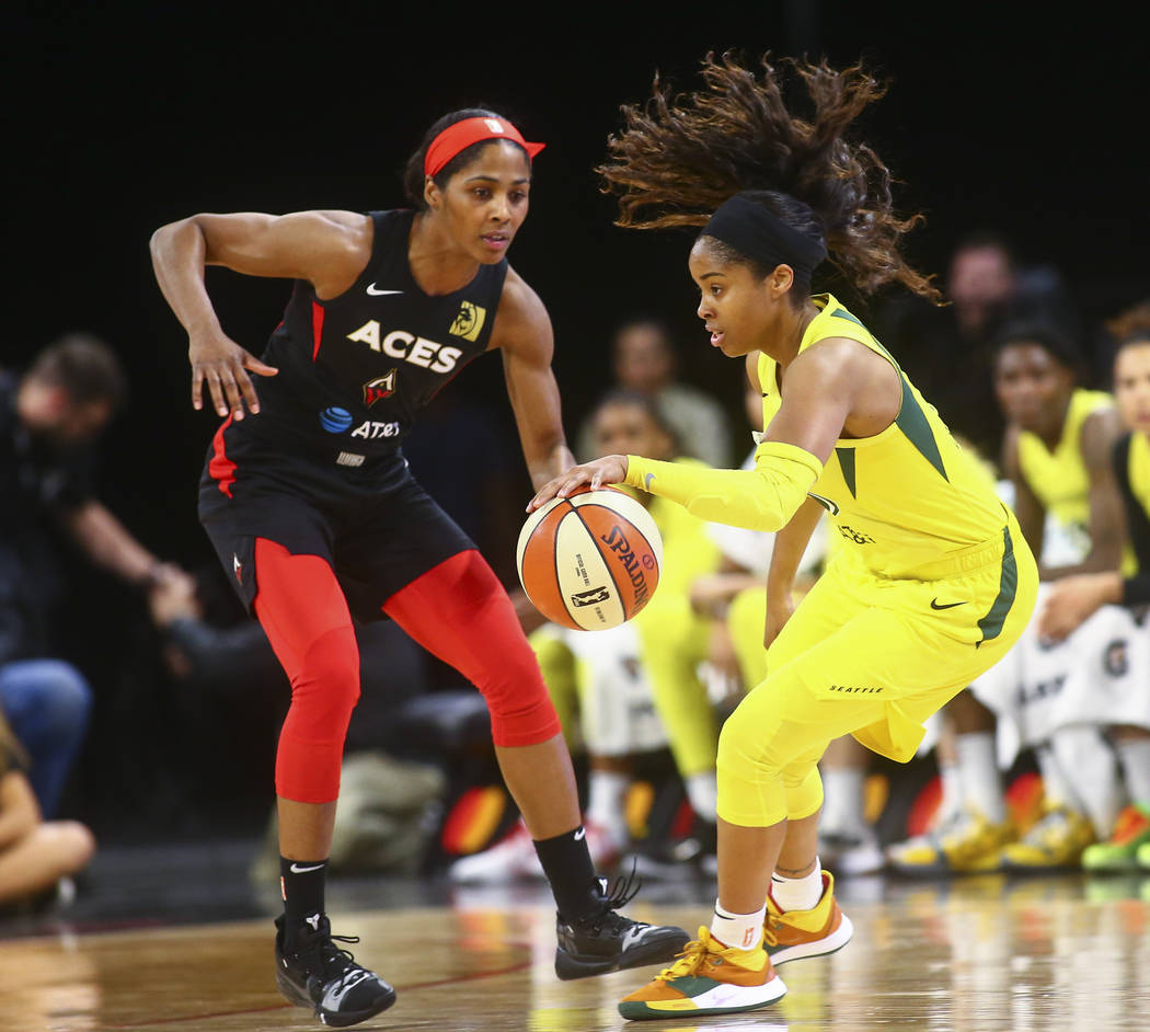 Seattle Storm guard Jordin Canada, right drives the ball under pressure from Las Vegas Aces gua ...