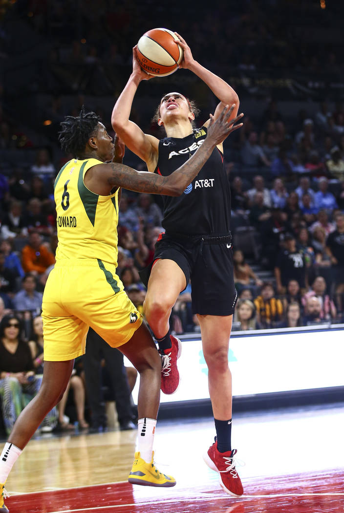 Las Vegas Aces forward Dearica Hamby (5) goes to the basket against Seattle Storm forward Natas ...