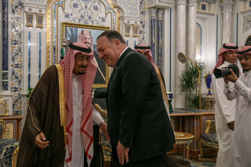 Secretary of State Mike Pompeo leans in to greet Saudi Arabia's King Salman during their meetin ...