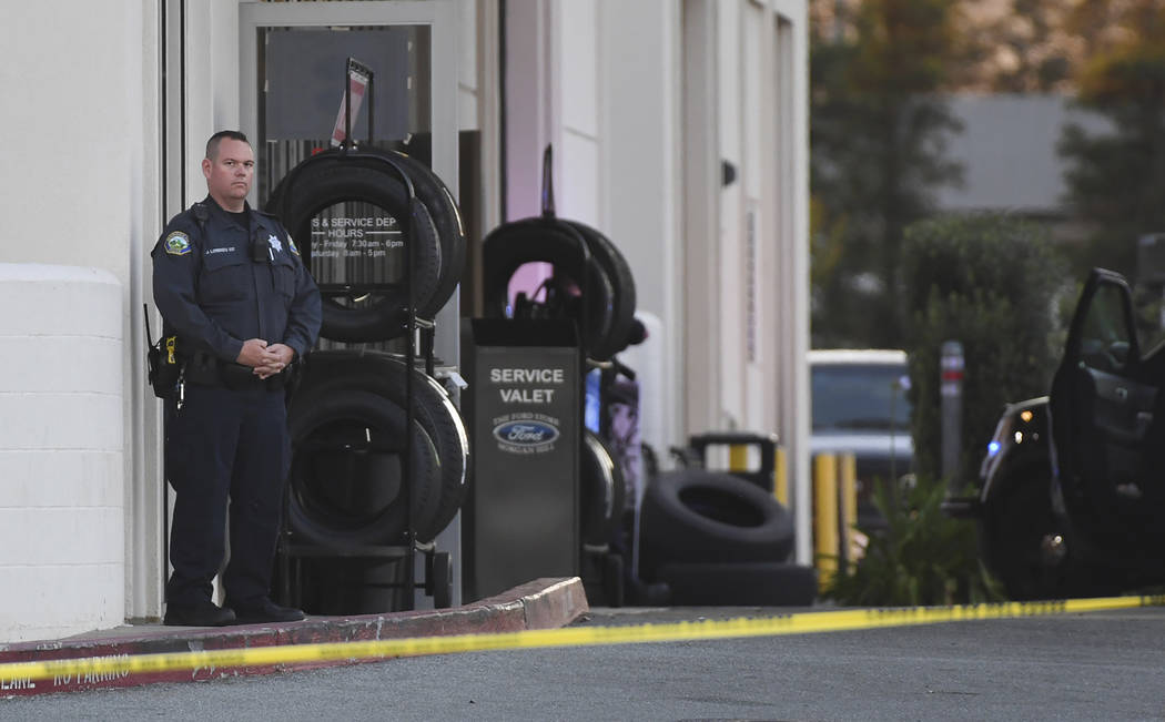 Police investigate at the scene of a shooting at the Morgan Hill Ford Store in Morgan Hill, Cal ...