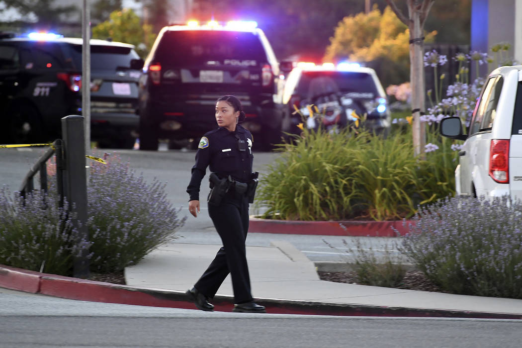 Police investigate at the scene of a shooting at the Morgan Hill Ford Store in Morgan Hill, Cal ...