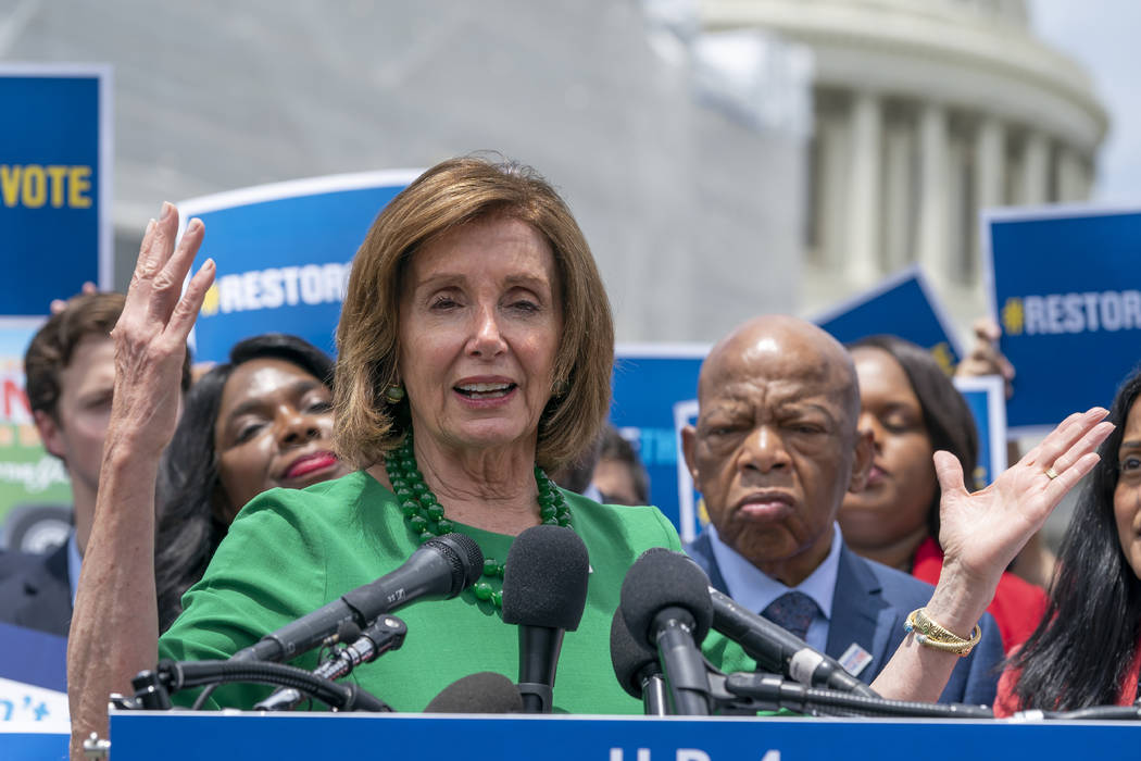 Speaker of the House Nancy Pelosi, D-Calif., flanked by Rep. Terri Sewell, D-Ala., left, and Re ...