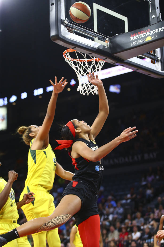 Las Vegas Aces center A'ja Wilson goes to the basket past Seattle Storm center Mercedes Russell ...