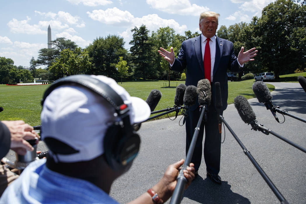 President Donald Trump talks with reporters before departing to Japan for the G20 summit on the ...