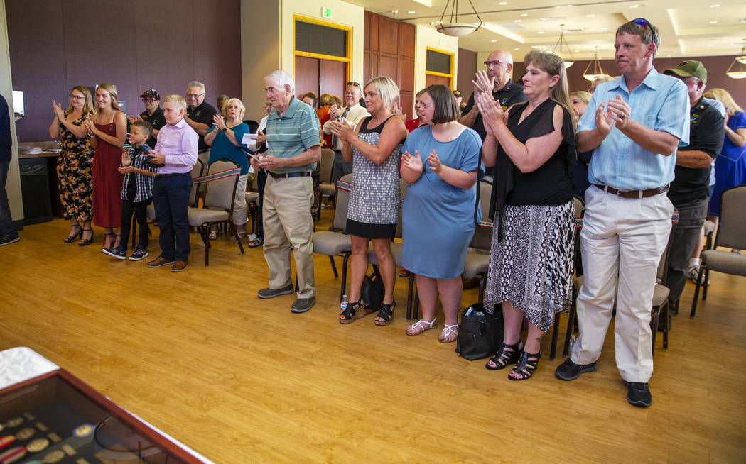 Invited stand and applaud as The Veterans Club of Sun City Aliante and the city of North Las Ve ...