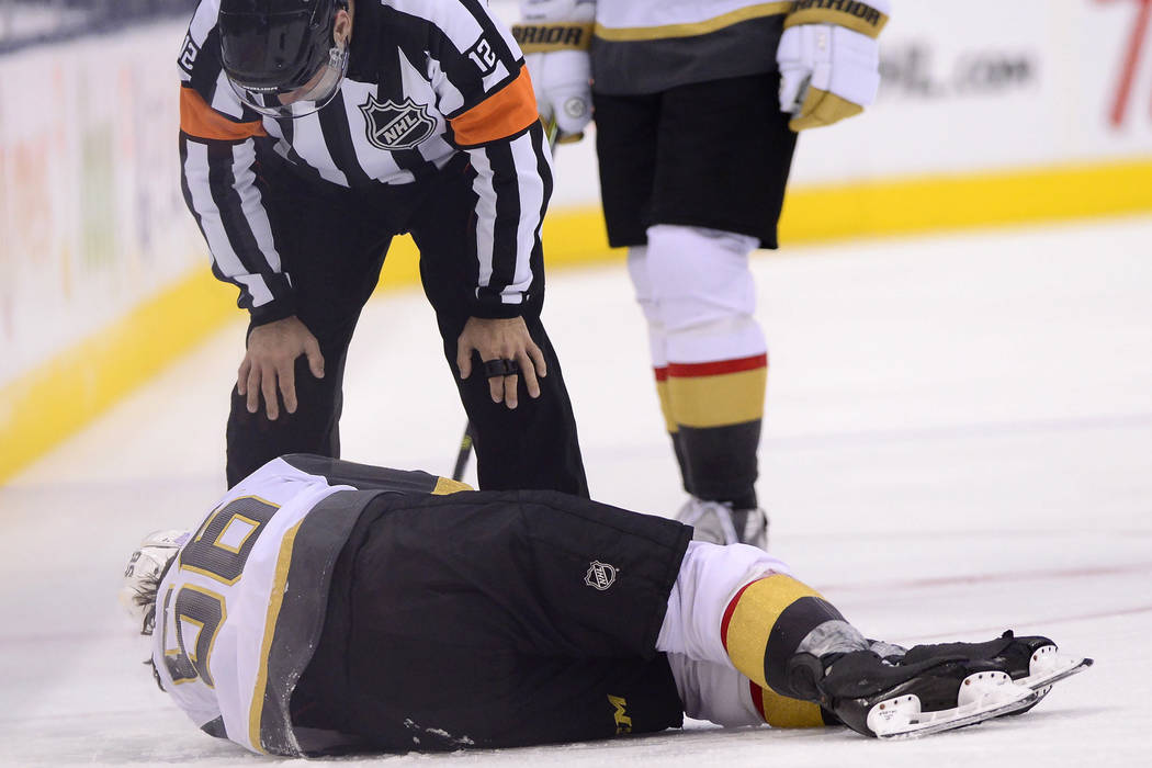 Vegas Golden Knights center Erik Haula (56) lies on the ice after taking a hit along the boards ...