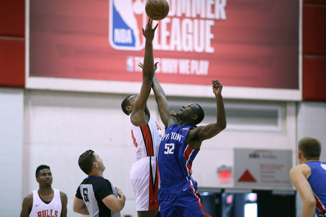 Chicago Bulls' Wendell Carter Jr. (34), and Detroit Pistons' Nnanna Egwu (52) jump for the ball ...
