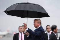 President Donald Trump waves after arriving at Osaka International (Itami) Airport, in Osaka, J ...