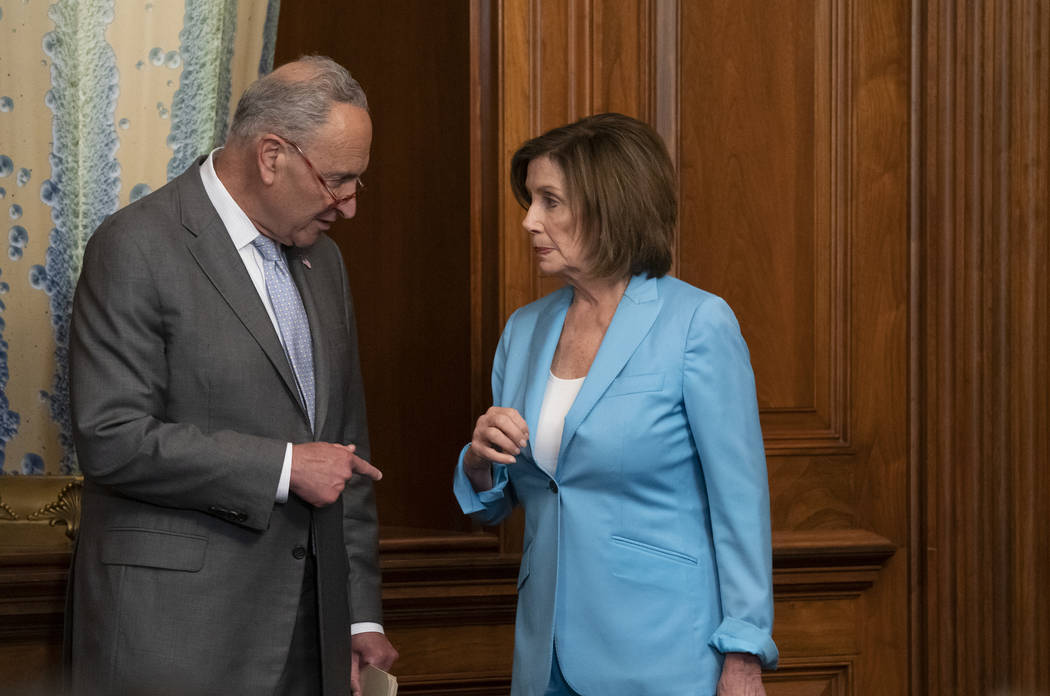 Senate Minority Leader Chuck Schumer, D-N.Y., left, talks with Speaker of the House Nancy Pelos ...