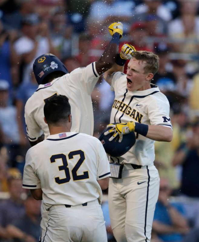 Michigan's Jimmy Kerr, right, celebrates after hitting a 2-run home run against Vanderbilt duri ...