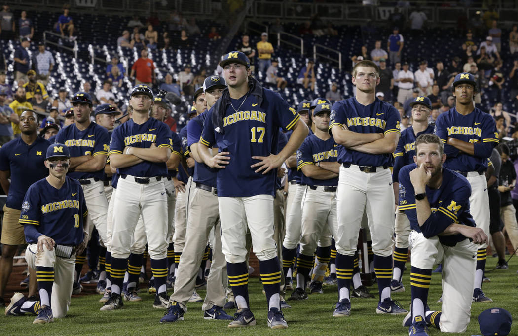 Michigan players including Jeff Criswell (17) watch as Vanderbilt celebrates after Vanderbilt d ...