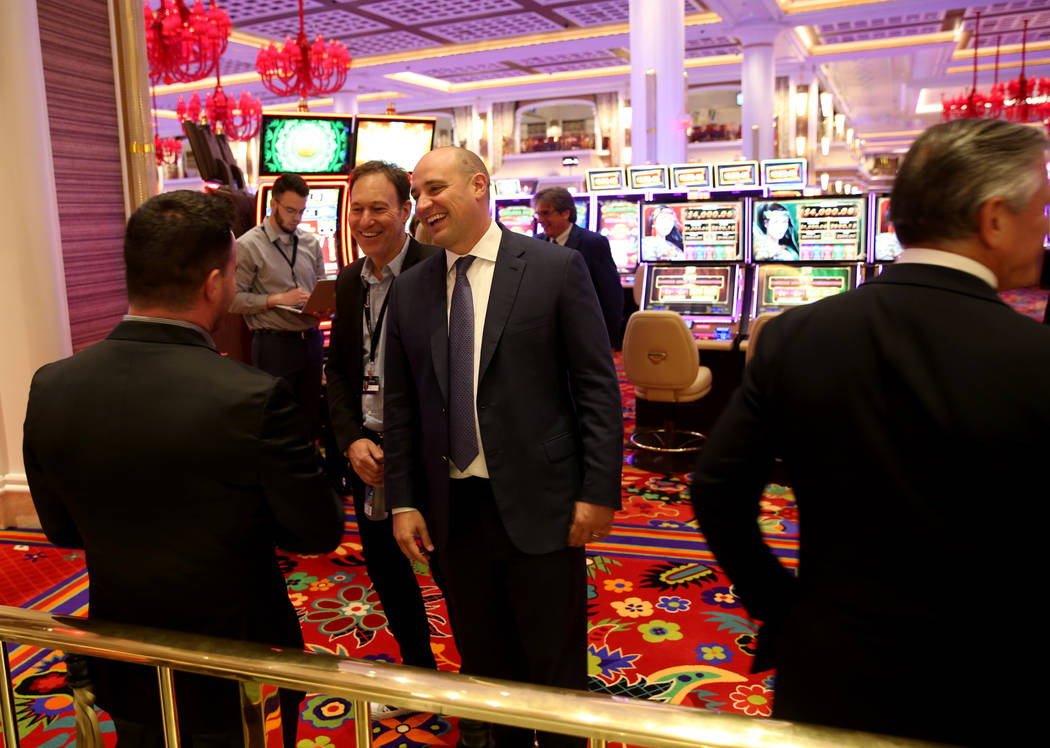 Wynn Resorts CEO Matt Maddox right, visits with Randy Greenstein, left, and Ed Kane, owners of ...