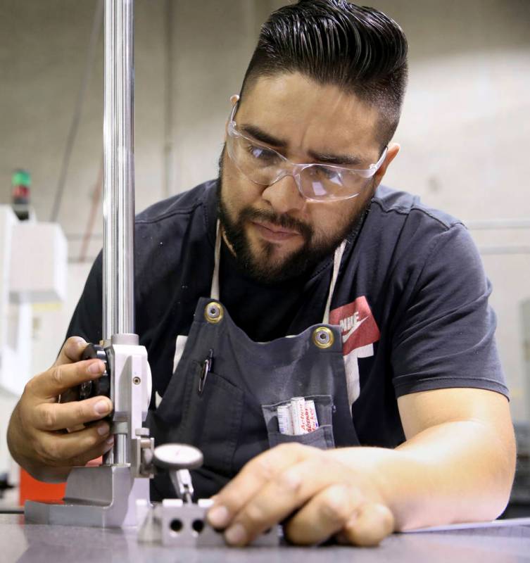 Machinist Omar Garatachia checks custom hinges at Aerospace Machine and Supply in North Las Veg ...