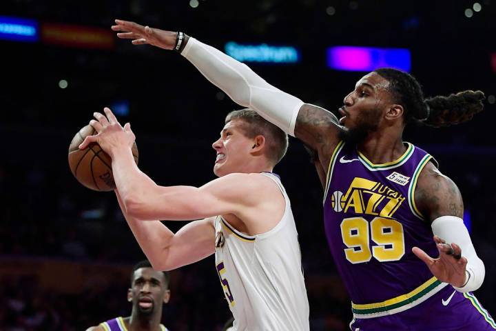 Los Angeles Lakers center Moritz Wagner, left, tries to shoot as Utah Jazz forward Jae Crowder ...